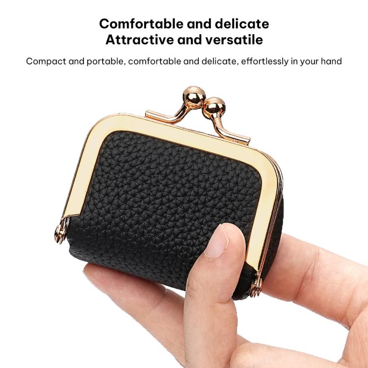 Black mini jewelry bag held in hand with gold-tone kiss-lock clasp