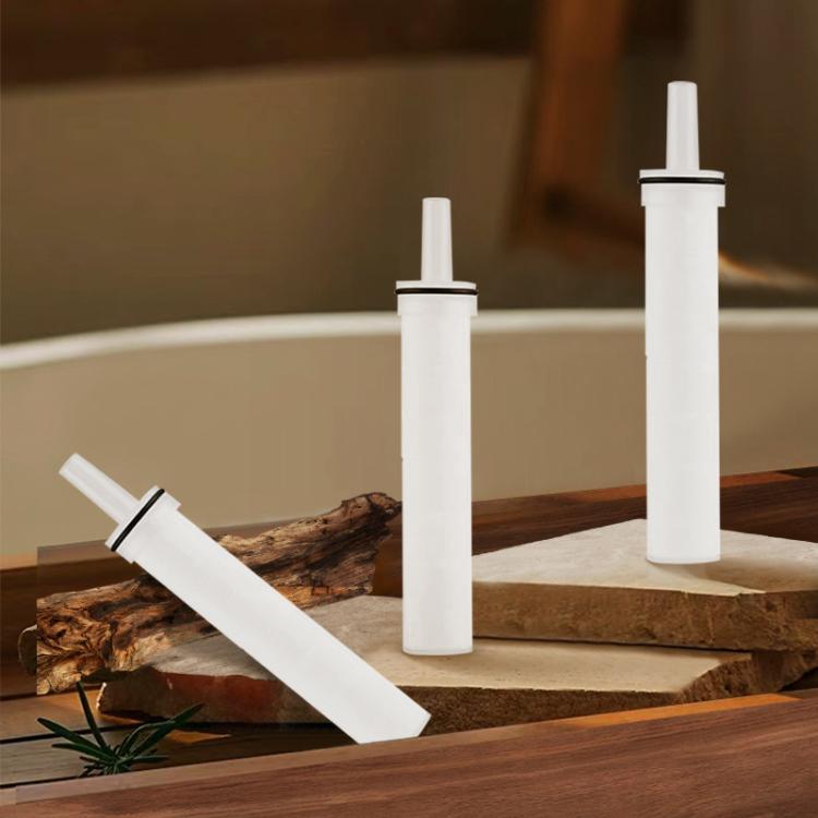 Shower filter cartridge set of five, white PP cotton filters standing on tray