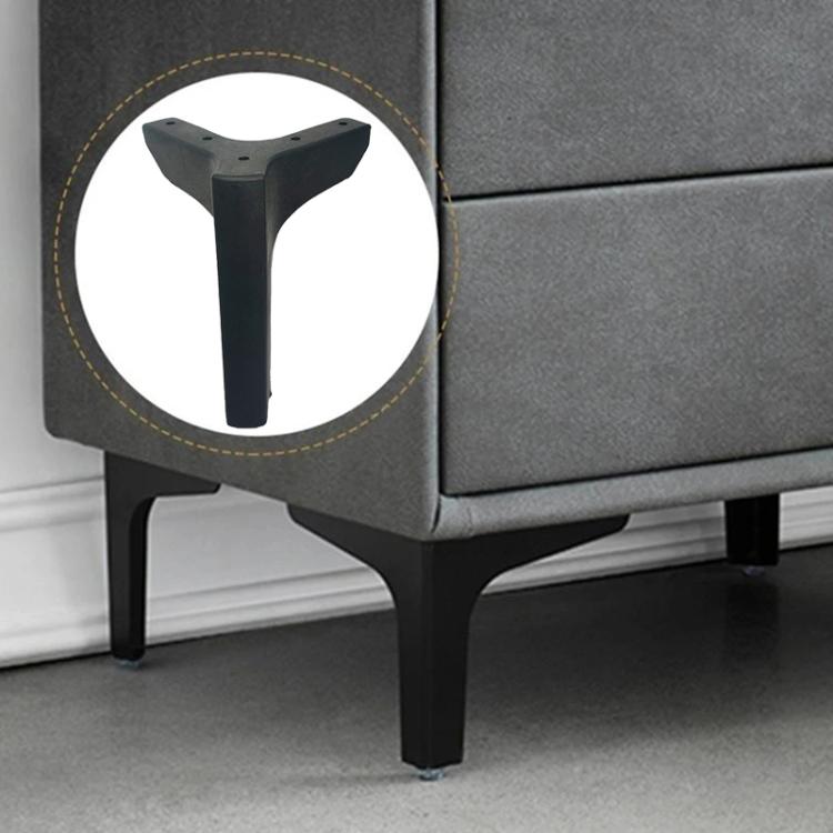 Metal three-pronged support leg bracket installed under a sofa frame, dark finish
