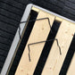 Black anti-slip guardrail strips clipped onto light wood bed frame