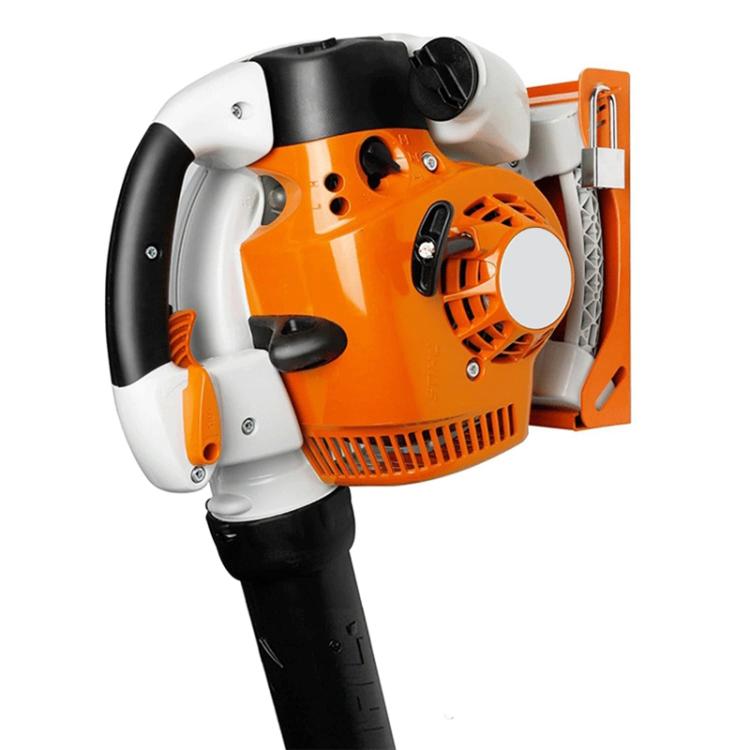 Handheld blower mounted in an orange wall storage rack bracket