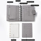 Light gray passport holder notebook open, showing card slots and pen holder