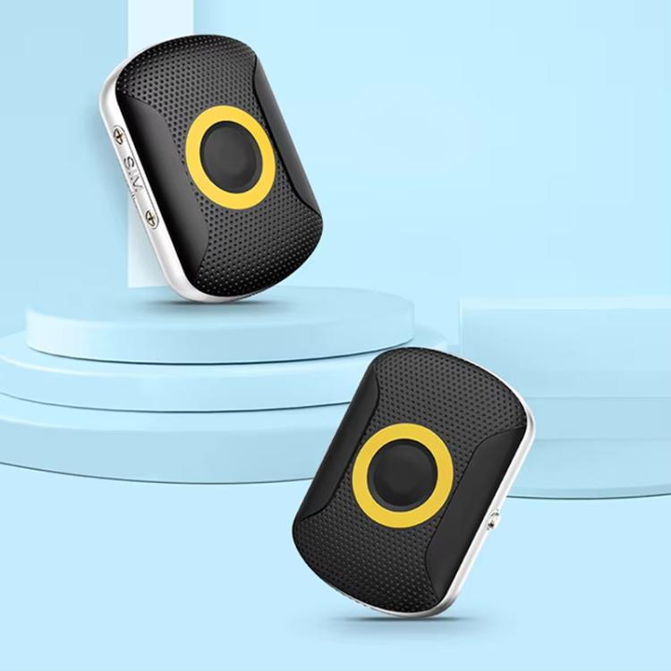 Black GPS location tracker with yellow-ring button, angled view on light surface