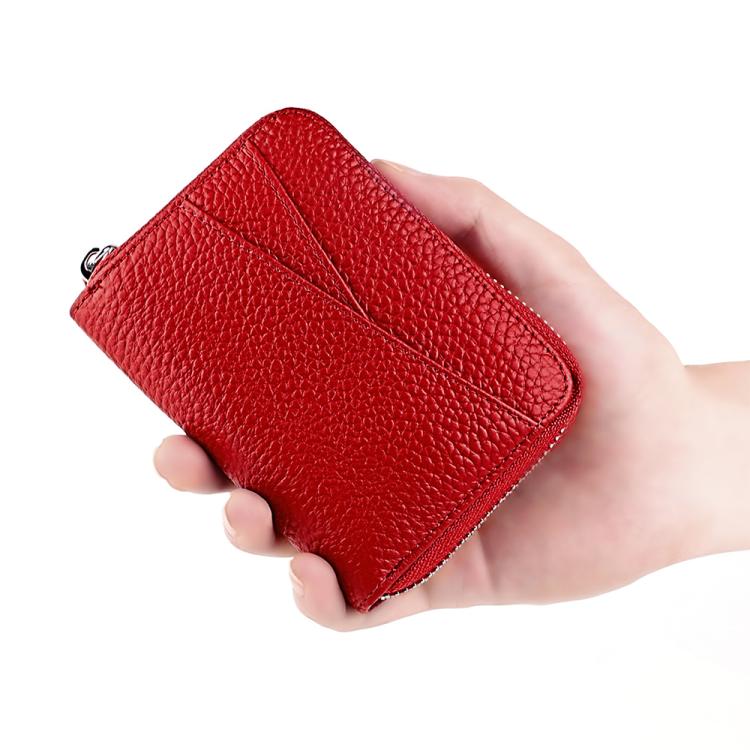 Red genuine leather zip card holder held in hand