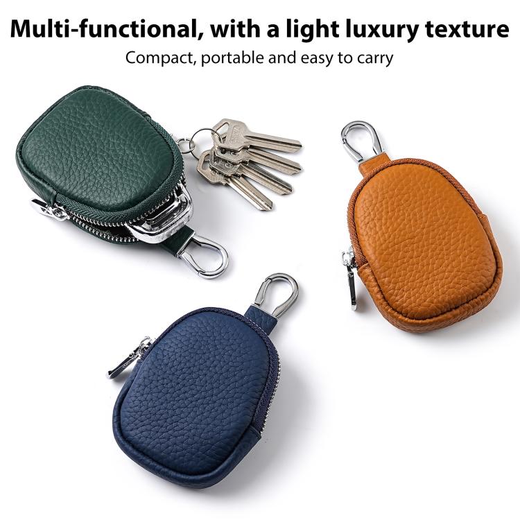 Set of mini leather coin bag keychains in dark green, navy, and orange, with zippers