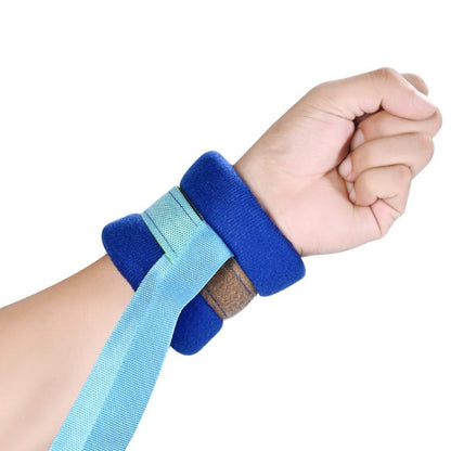 Blue and light-blue limb restraint strap with cushioned cuff and adjustable loop closure.