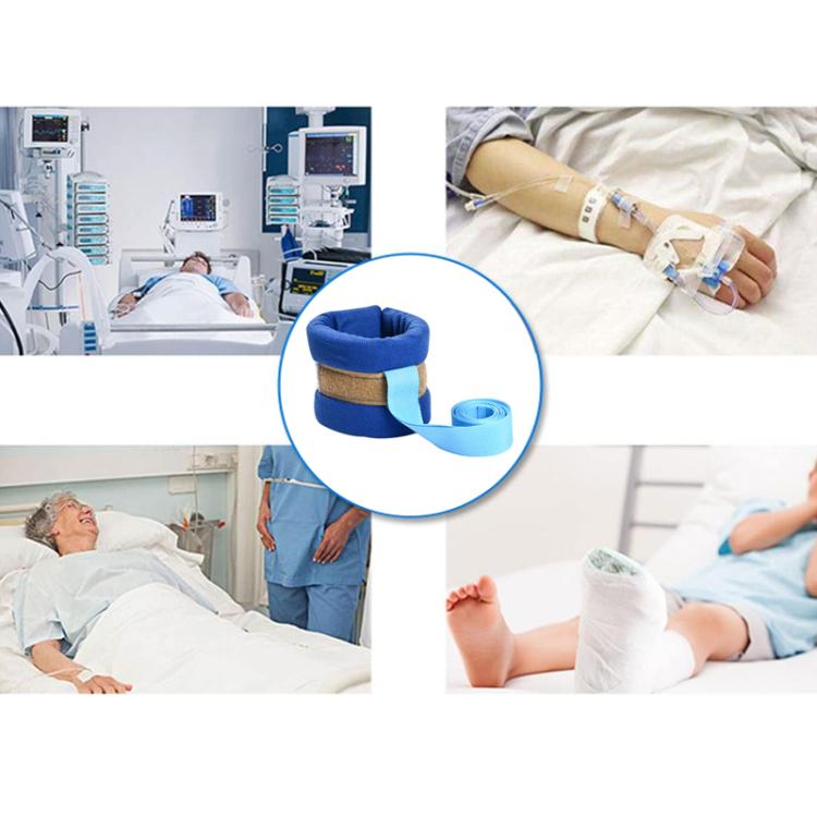 Blue wrist/arm cuff with light-blue strap securing a patient’s limb.