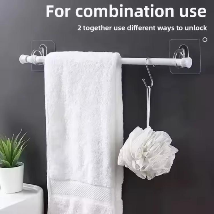 Transparent adhesive hooks holding towels and bath items on wall