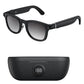 Black smart glasses with gradient lenses and a black charging case with digital display