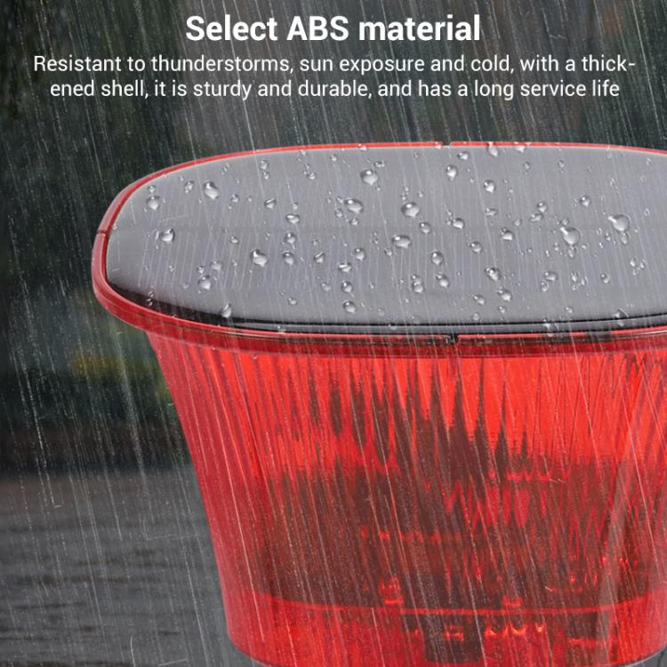 Rain-covered red translucent solar animal repellent with black base and solar panel
