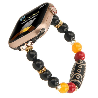 Beaded Apple Watch band with black, red, and yellow beads and a patterned focal bead