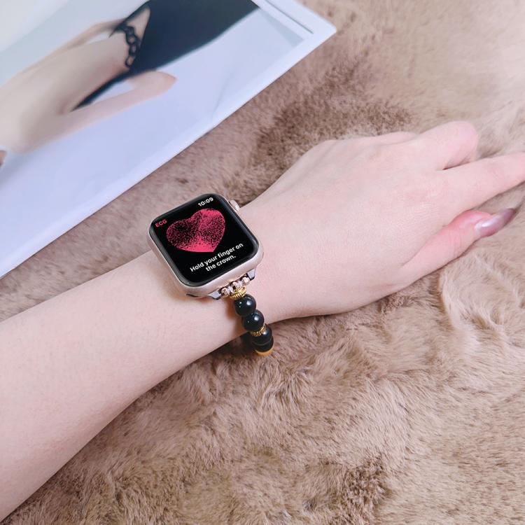 Beaded Apple Watch band with black, red, and yellow beads, shown on a wrist