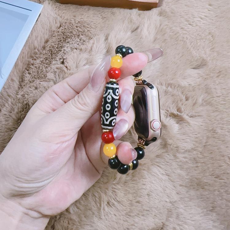Beaded Apple Watch band with a black patterned focal bead and red and yellow accents