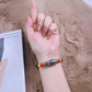 Beaded Apple Watch band worn as a bracelet, with a black patterned focal bead