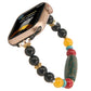 Beaded Apple Watch band with black beads, red and yellow accents, and a green patterned focal bead