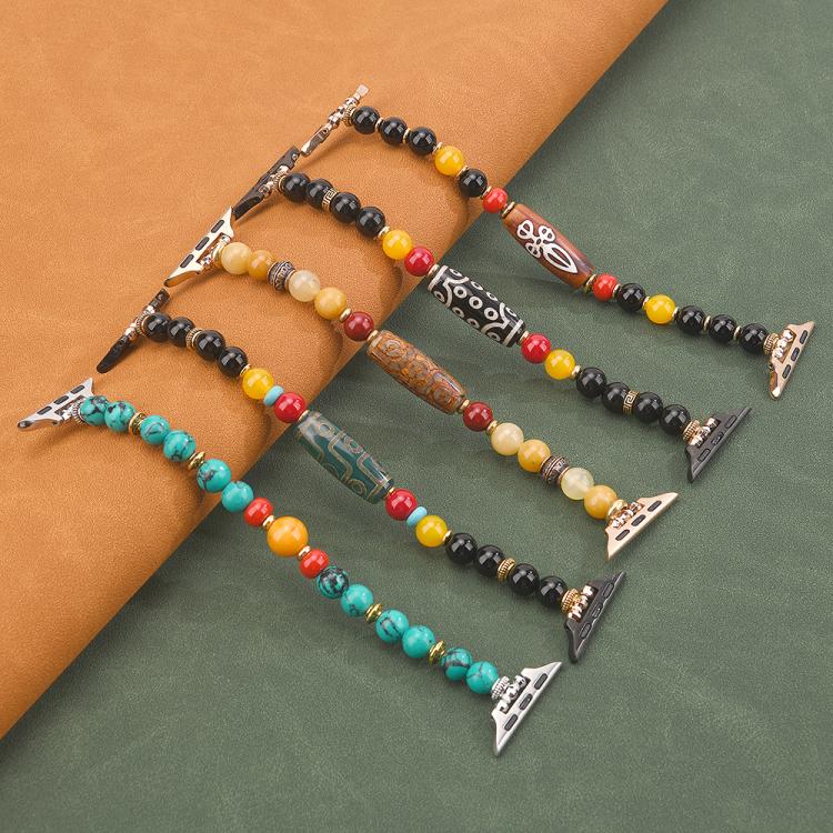 Five beaded Apple Watch bands in turquoise, black, amber, and mixed colors, shown laid out