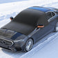 Black windshield snow cover on car with orange-trimmed magnetic side tabs