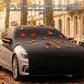 Half car cover with orange leaf pattern on dark textured fabric and orange trim details.
