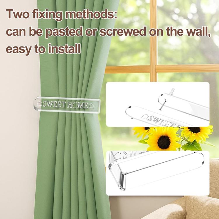 Clear acrylic curtain tieback holder clip securing green drapery