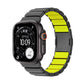Dark gray Apple Watch band with bright yellow-green inner links, shown attached to a watch.