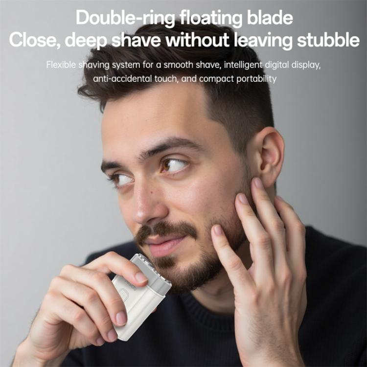 Portable electric shaver being used on a man's cheek, two rotating heads visible