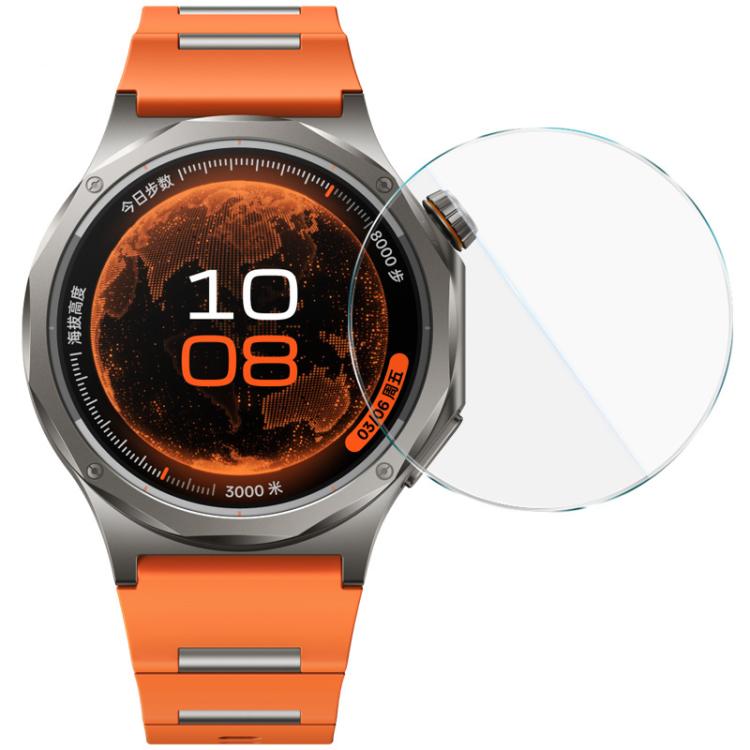 Clear round tempered glass watch protector beside an orange-band smartwatch