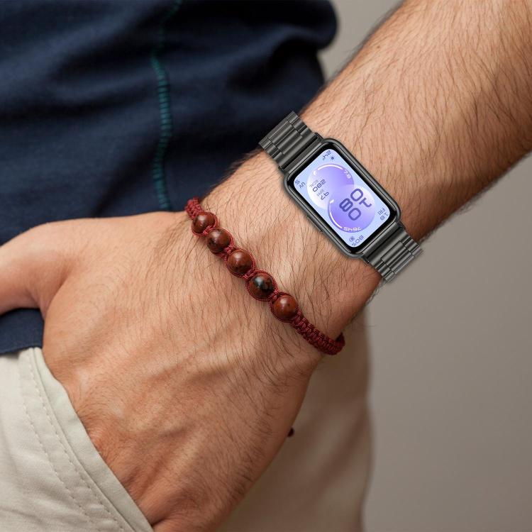 Black metal watch band worn on a wrist with a smartwatch