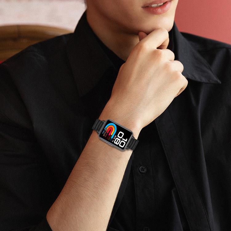 Black textured metal watch band worn on the wrist