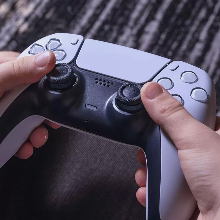 Hand pressing a dark gray silicone aiming ring onto a controller thumbstick