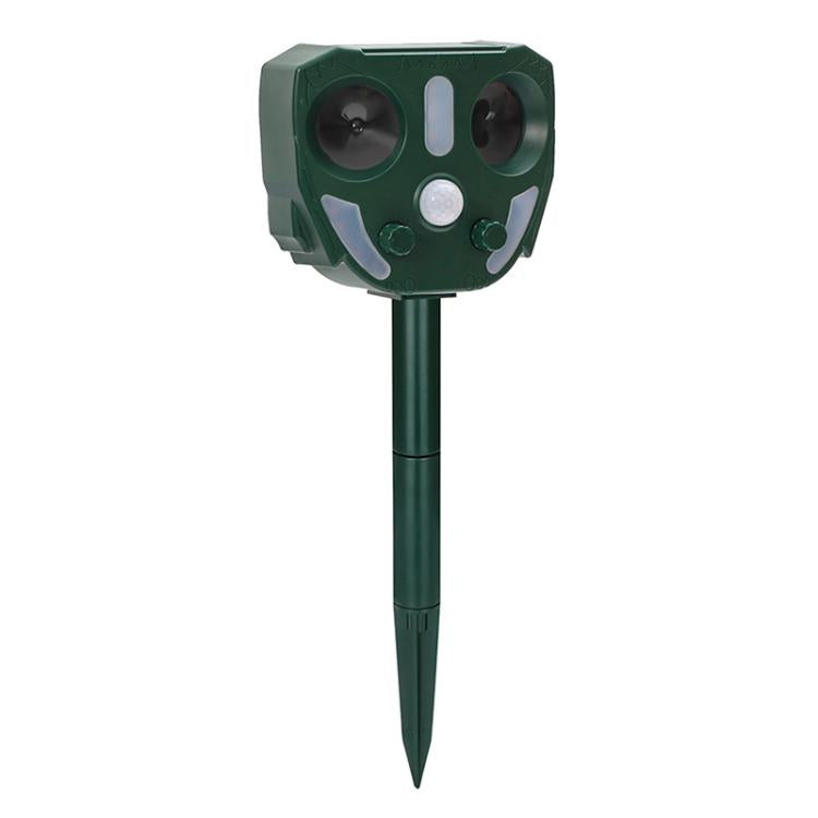 Outdoor solar animal repellent device with dark green housing, two speaker openings, and white indicator