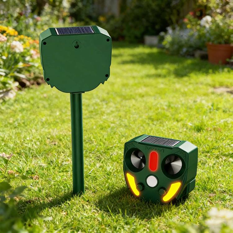 Outdoor solar animal repellent unit with solar panel top, red center light, and yellow side indicators