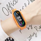 Orange silicone watch strap with smartwatch display on wrist