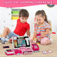 Pink shopping cash register playset on floor table while children play