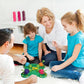 Family playing turtle bean-eating game toy with colorful turtle shells and beads