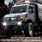 Silver gray RC off-road truck with illuminated headlights and roof light bars.