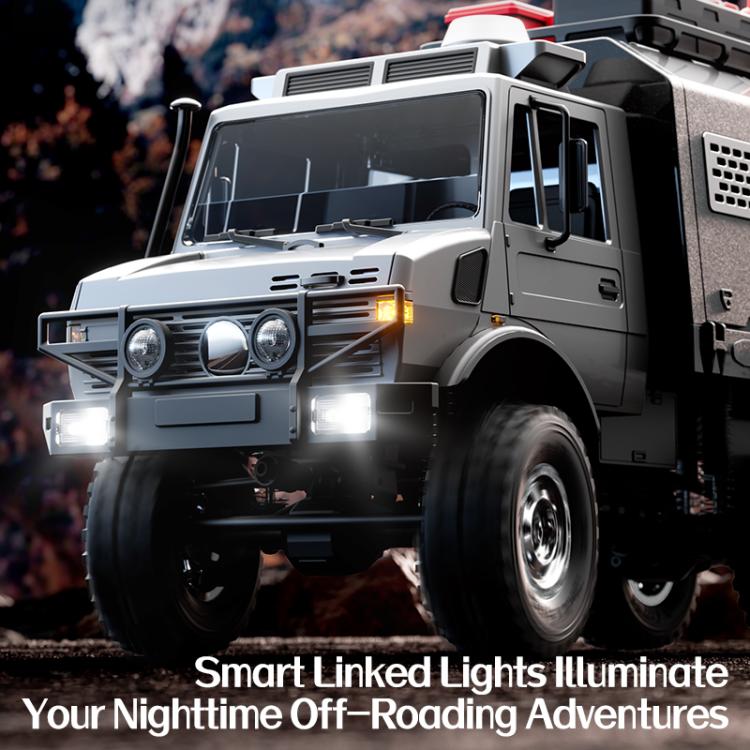 Silver gray RC off-road truck with illuminated headlights and roof light bars.