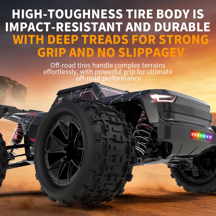 Black RC monster truck front wheel with deep-tread tires and glowing light bar