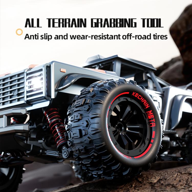 Silver off-road remote control truck wheel with red shock absorber and off-road tires