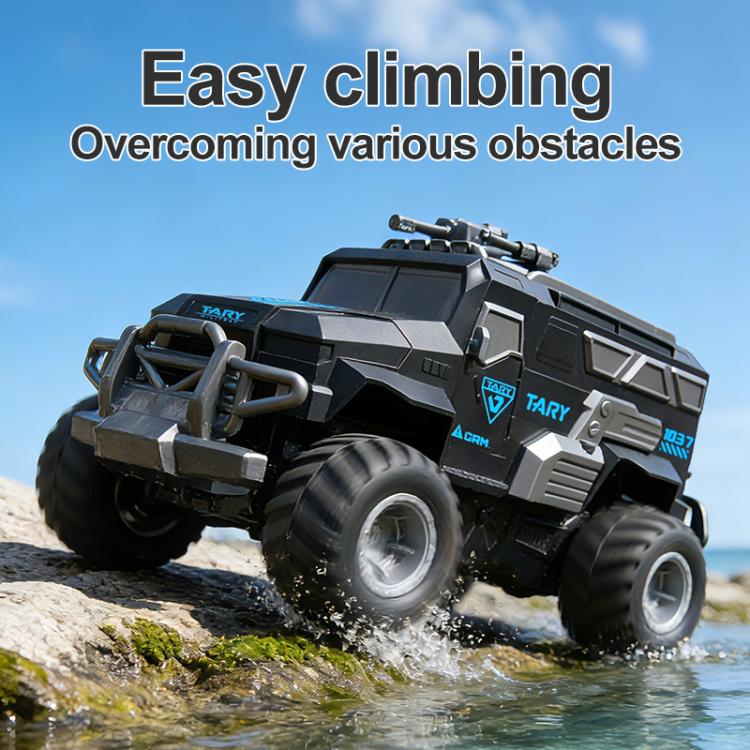 Dark gray remote-control amphibious armored vehicle climbing over rocks near water
