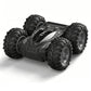 Black RC stunt car with large off-road tires, rugged body, and gray accents on hood.