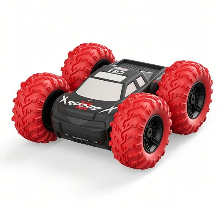 Red RC stunt car with large tread off-road tires and gray-black body paneling.
