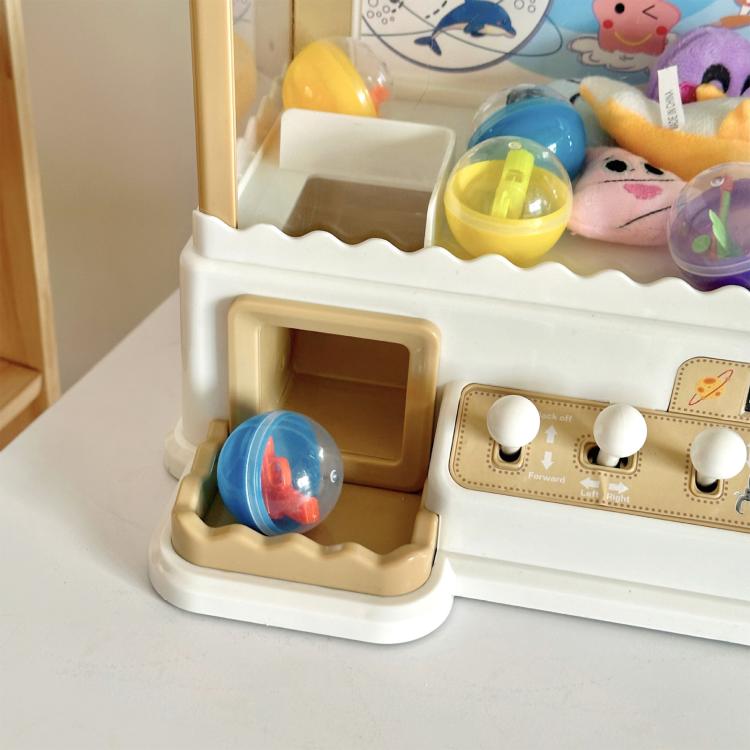 Mini claw game machine prize chute and control panel with colorful capsule toys