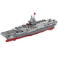 Remote-controlled aircraft carrier toy with gray deck, red hull, and red mast flag.