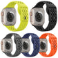 Five perforated silicone watch bands in lime, black, gray, navy, and orange, shown on watches.