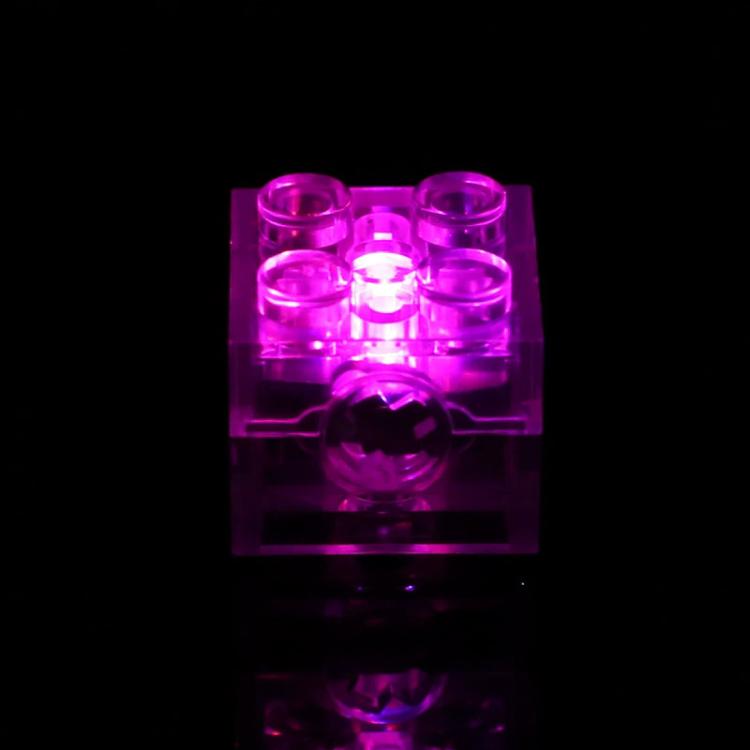 Translucent LED building-block cube glowing magenta purple