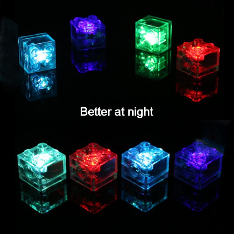 Clear 2x2 LED building blocks glowing blue, green, red, and purple