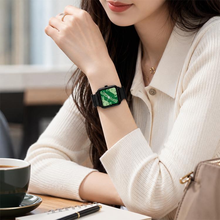 Square quartz watch worn on wrist with green dial and black nylon band