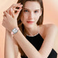 Ladies square quartz watch on wrist with light pink leather strap and silver-toned case