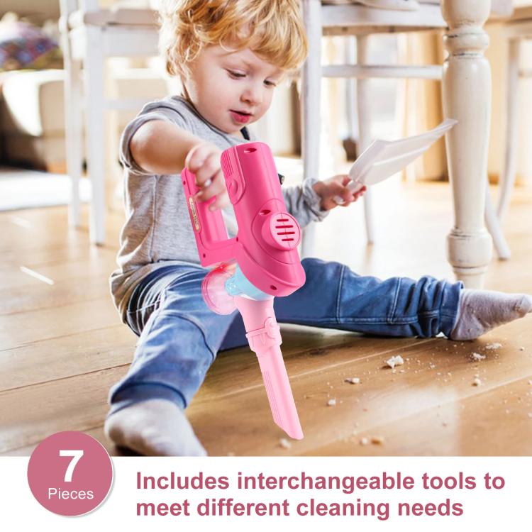 Pretend vacuum cleaner toy held in hands, pink body with blue nozzle and base stand