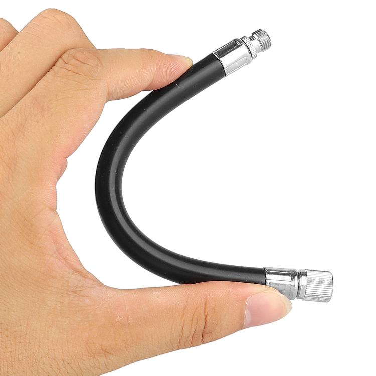 Black inflation extension cable held by hands with metal valve tips